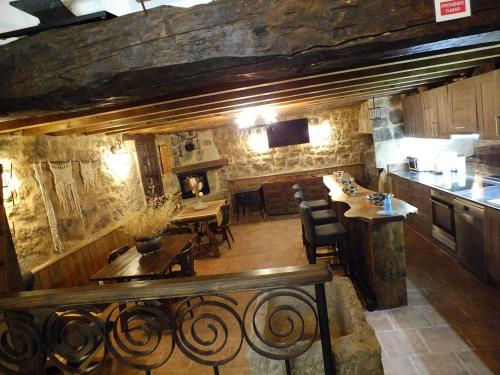 a kitchen and dining room with a table and chairs at La Bodeguita in Cuzcurrita-Río Tirón