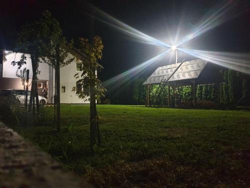 a light shines on a house in a yard at night at Luxury house "Heart of Nature" Visoko in Visoko