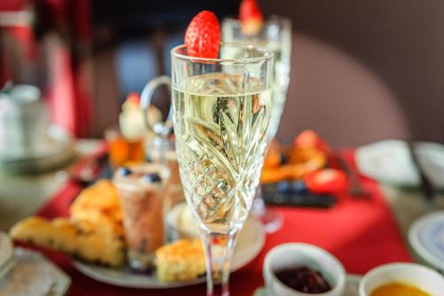 a glass of champagne with a strawberry in it on a table at Sea Villa in Ardgroom