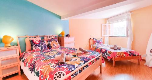 a bedroom with two beds and a window at Ericeira Surf Camp in Ericeira