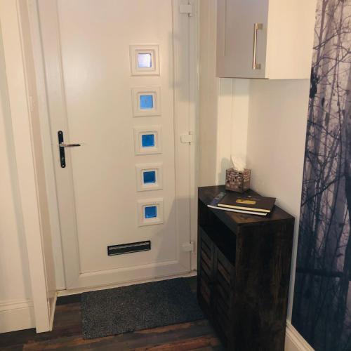 a room with a door and a table with a box at The Coop in Castle Douglas