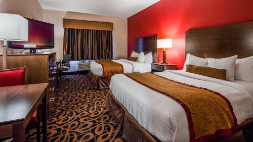 a hotel room with two beds and a television at Best Western Plus Brandywine Inn & Suites in Monticello