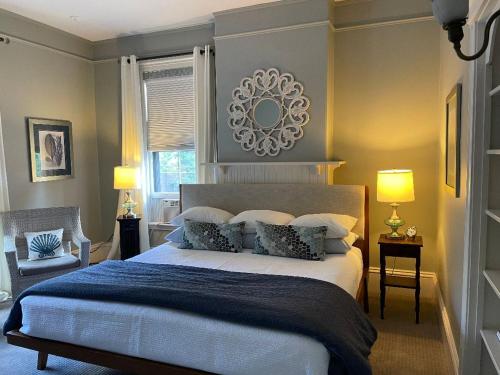 a bedroom with a large bed and a mirror on the wall at West End Inn in Portland