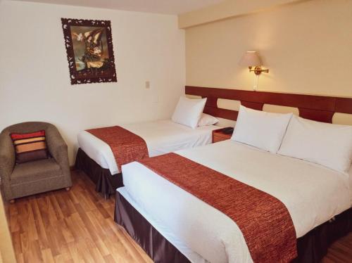 a hotel room with two beds and a chair at Awki´s Dream Hotel in Cusco