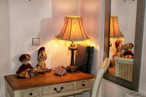 a table with a lamp and some figurines on it at Viktoria's apartment in the center of Parga in Parga
