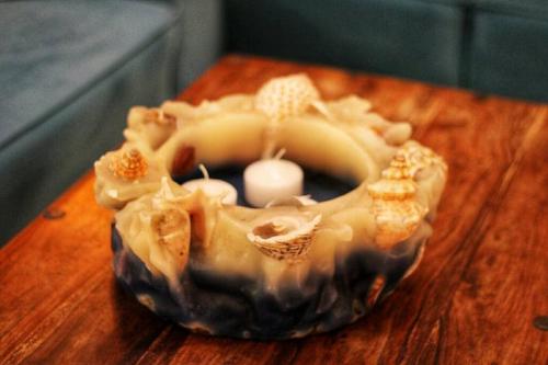 a donut sitting on top of a wooden table at Viktoria's apartment in the center of Parga in Parga