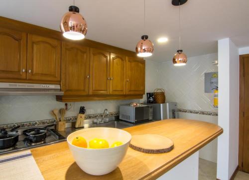 a kitchen with a bowl of oranges on a counter at Alcazar de Oviedo by EE Hoteles in Medellín