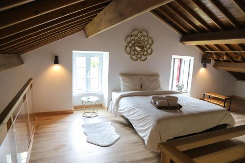 a bedroom with a large bed in a attic at Sete Cidades Nature Villa in Sete Cidades
