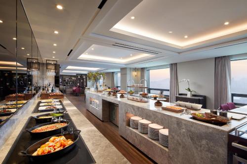 a buffet line in a hotel with food at Lotte Hotel World in Seoul