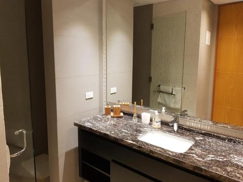 a bathroom with a sink and a mirror at H2 Hyatt Vista Mar!! in Cartagena de Indias