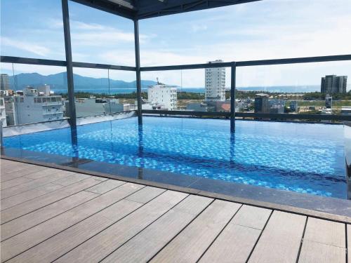 a swimming pool on the roof of a building at The Shine Hotel & Apartment in Da Nang