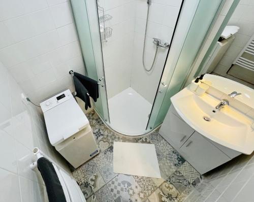 a bathroom with a sink and a shower at ZAROHEM 2 bedrooms APARTMENT in center with balcony in Brno