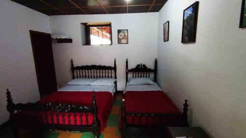 a bedroom with two beds in a room at Hotel Cacique Chalalá in Charalá