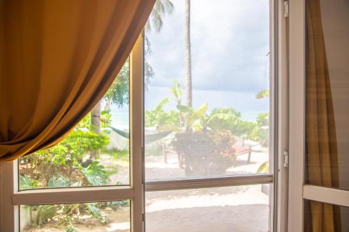 an open window with a view of the beach at Surfescape Zanzibar in Kiwengwa