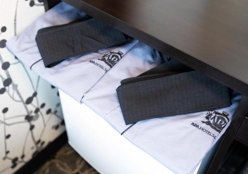 a drawer with three black and white napkins at APA Hotel Kobe Sannomiya Ekimae in Kobe