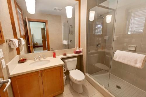 a bathroom with a shower and a toilet and a sink at Admira Properties - Whistler in Whistler