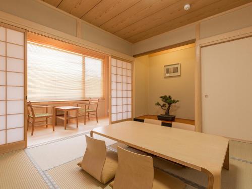 a dining room with a table and chairs at Racine Home Harie in Takashima