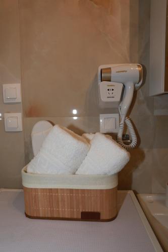 a blow dryer in a bathroom with a toilet at Bianca Suites in Nea Moudania