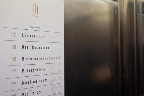 a close up of a restaurant menu next to a refrigerator at Draconerium Hotel in Dronero