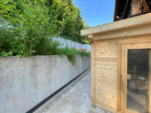 a wooden shed next to a concrete wall at Zur Nandl in St. Wolfgang