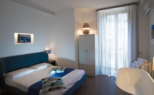 a small bedroom with a bed and a window at B&B Vietri Centro 2 in Vietri sul Mare