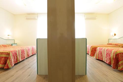 
Postel nebo postele na pokoji v ubytování Hotel San Marco
