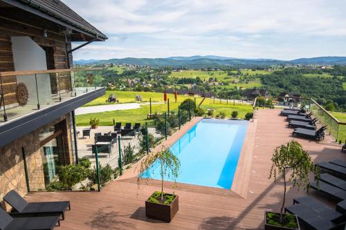 a view from the balcony of a hotel with a swimming pool at Złoty Groń Resort & Spa in Istebna