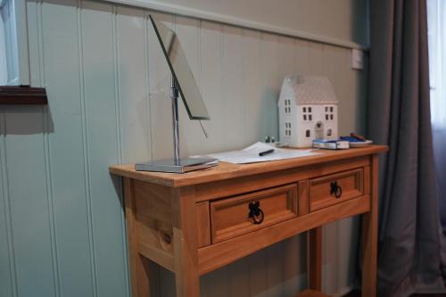 a desk with a lamp and a house on it at Mountainview in Ballyward
