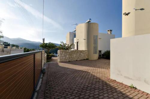 a balcony of a house with a fence at Creta Vivere Villas in Agia Pelagia