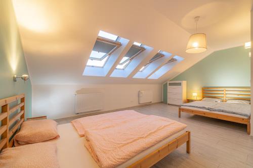 a large bedroom with a bed and a skylight at Apartament Rodzinny Plus Mountain Aparts in Świeradów-Zdrój