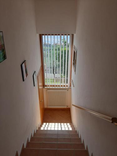 a hallway with a staircase with a large window at Apartment Maria in Brenzone sul Garda