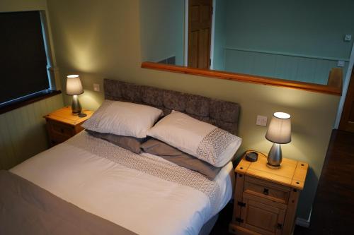 1 dormitorio con 1 cama con 2 mesitas de noche y 2 lámparas en Mountainview en Ballyward