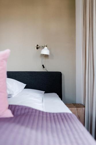 a bedroom with a bed with a lamp on it at Sommers "Schöne Aussicht", Adults only in Reichenbach im Vogtland