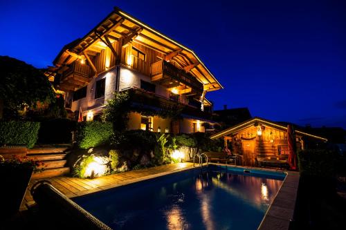 a house with a swimming pool at night at Landhaus Kitzblick in Piesendorf