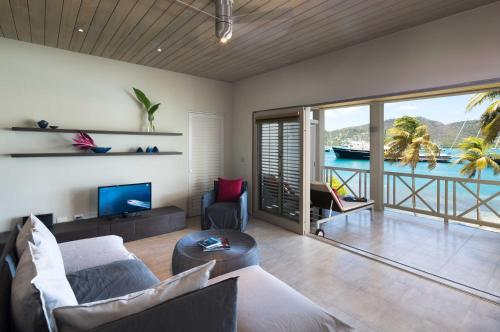 a living room filled with furniture and a large window at South Point Antigua in English Harbour Town