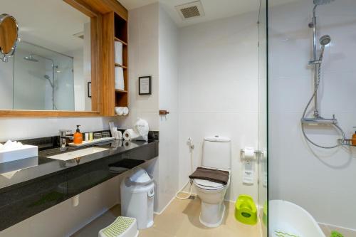 a bathroom with a sink, toilet, and mirror at Sunwing Kamala Beach - SHA Plus in Kamala Beach