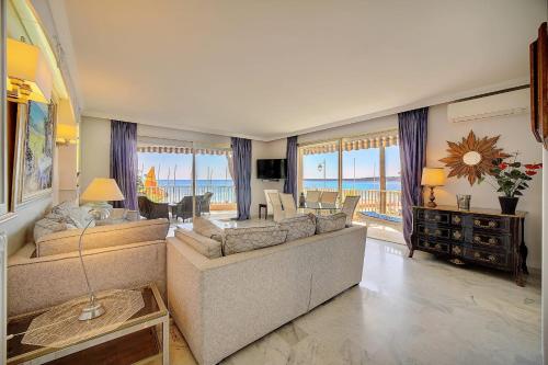 - un salon avec un grand canapé et une table dans l'établissement IMMOGROOM- Huge Terrace - Panoramic Sea View - 1min from Beach, à Cannes