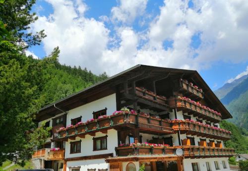 a building with balconies and flowers on it at Haus Waldesruh in Neustift im Stubaital