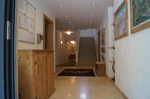 a hallway with a staircase and a stair case at Waidmannsruh Appartements in Gerlos