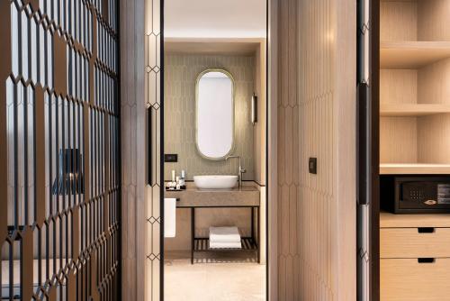 a bathroom with a sink and a mirror at Radisson Collection Hotel, Bodrum in Akyarlar