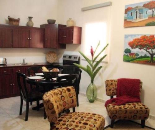 a kitchen and dining room with a table and chairs at Fortaleza Suites Old San Juan in San Juan