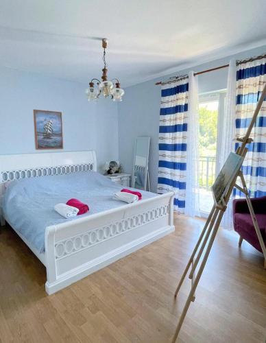 a painting of a bedroom with a bed and a camera at Blue Sky Apartments in Slatine