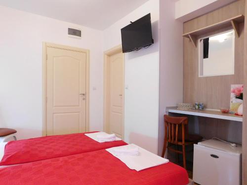 a bedroom with a red bed and a sink at Villa Jovana Sea View in Budva