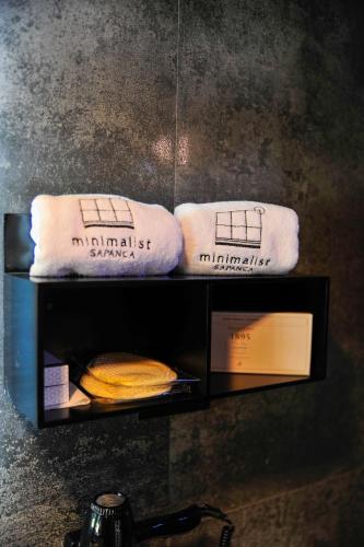 two towels sitting on a shelf in a bathroom at Minimalist Sapanca in Sapanca