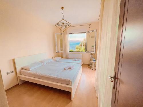 a small bedroom with a bed and a window at Dream Villa in Paleo Tsifliki