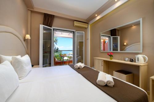a bedroom with a bed with a view of the ocean at Hotel Penelope in Boukari