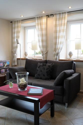 a living room with a couch and a table at Ferienhaus Eifel 1851 in Gipperath