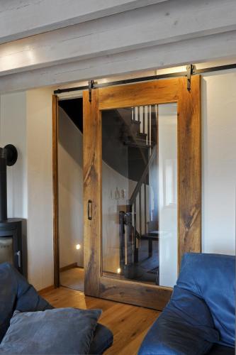 a mirror in a living room with a couch at Ferienhaus Eifel 1851 in Gipperath