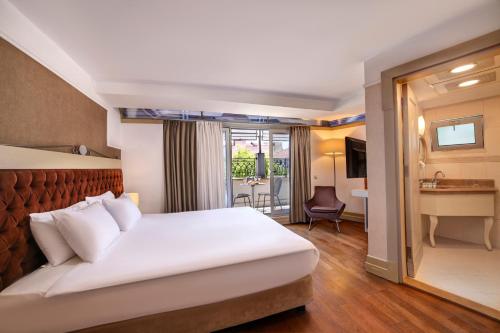 a hotel room with a large bed and a large window at Faros Hotel Old City - Special Category in Istanbul