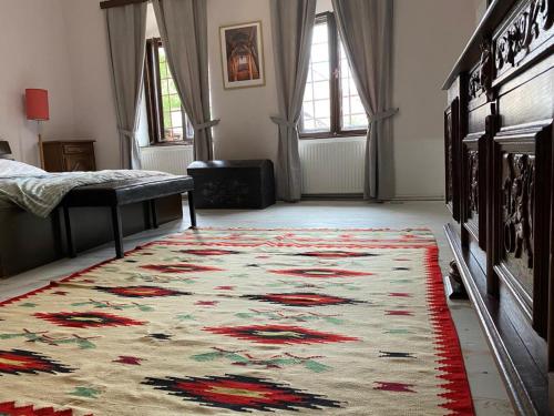a room with a rug on the floor with a bed and a rug at Casa Poetului in Sibiu